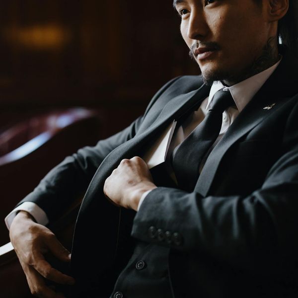 Office worker with a good posture sitting in a chair, feeling energetic and well.